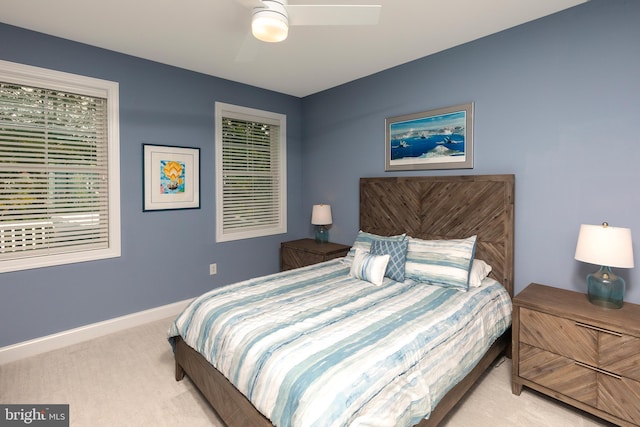 bedroom featuring light carpet and ceiling fan