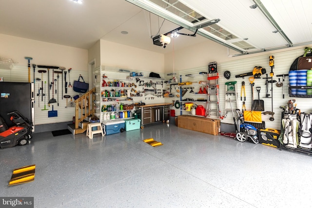 garage featuring a garage door opener and a workshop area