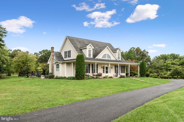 cape cod-style house featuring a porch and a front lawn