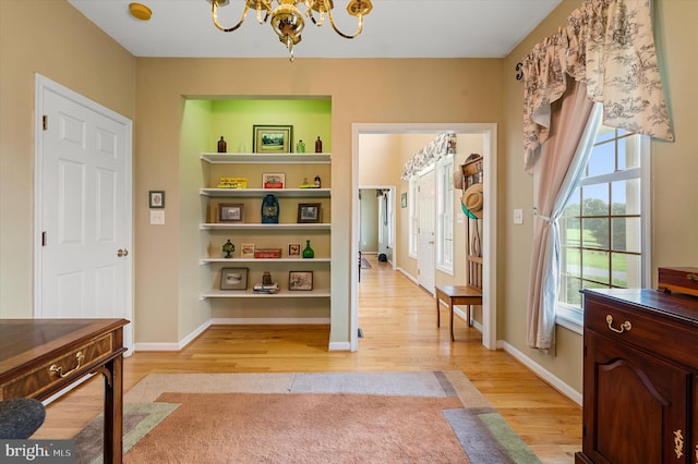 foyer featuring light hardwood / wood-style floors and an inviting chandelier