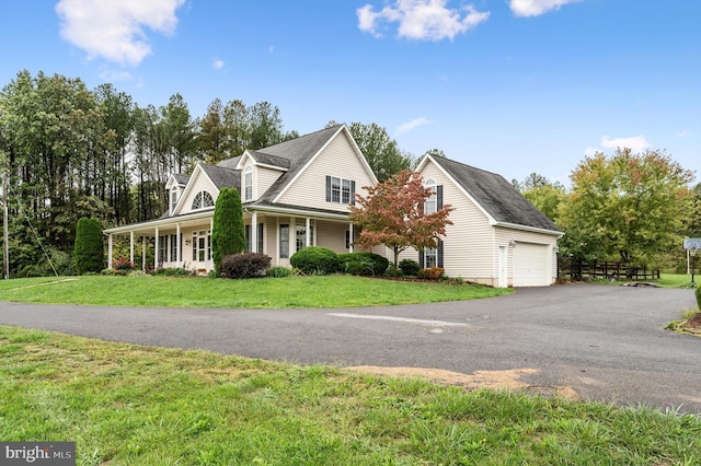 cape cod home with a front yard, a garage, and covered porch