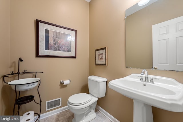 bathroom with sink, tile patterned flooring, and toilet