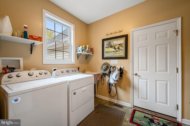 clothes washing area with independent washer and dryer