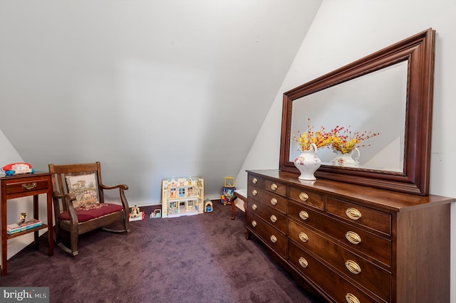 living area featuring dark colored carpet and vaulted ceiling