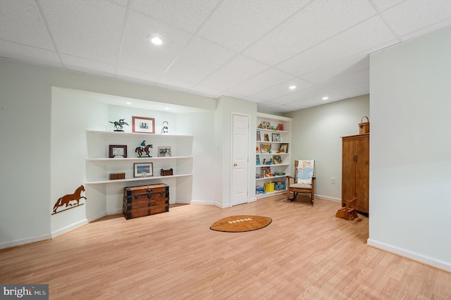 misc room featuring a paneled ceiling and hardwood / wood-style flooring