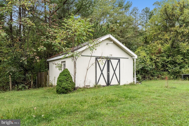 view of outbuilding featuring a yard