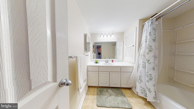 bathroom featuring tile patterned flooring, vanity, and shower / tub combo with curtain