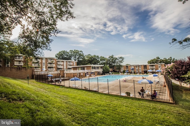 view of swimming pool with a yard and a patio