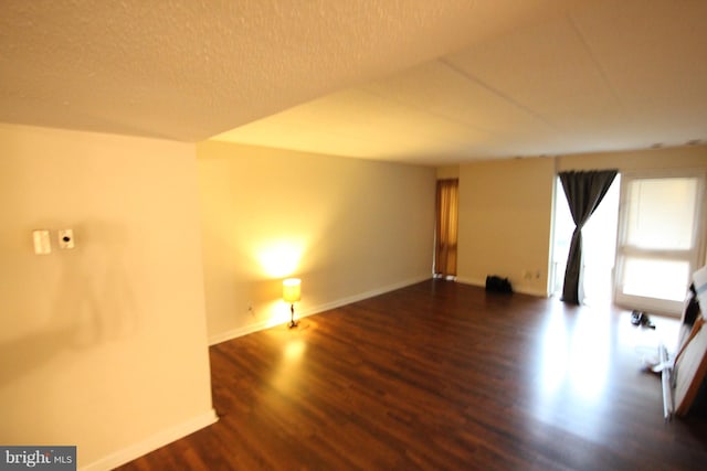 spare room featuring dark wood-type flooring