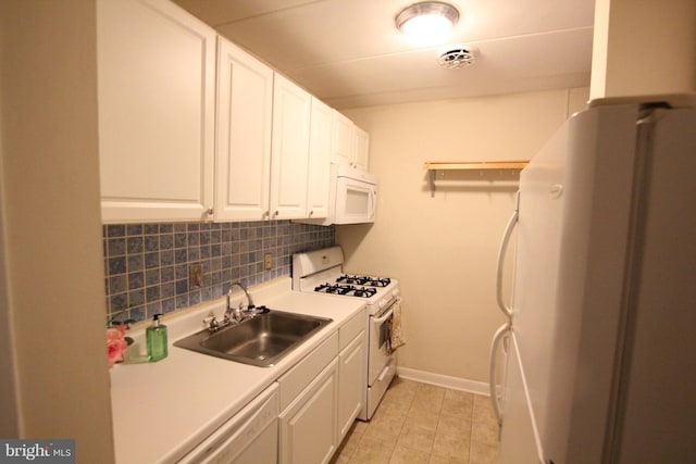 kitchen with light tile patterned flooring, sink, white cabinetry, white appliances, and decorative backsplash