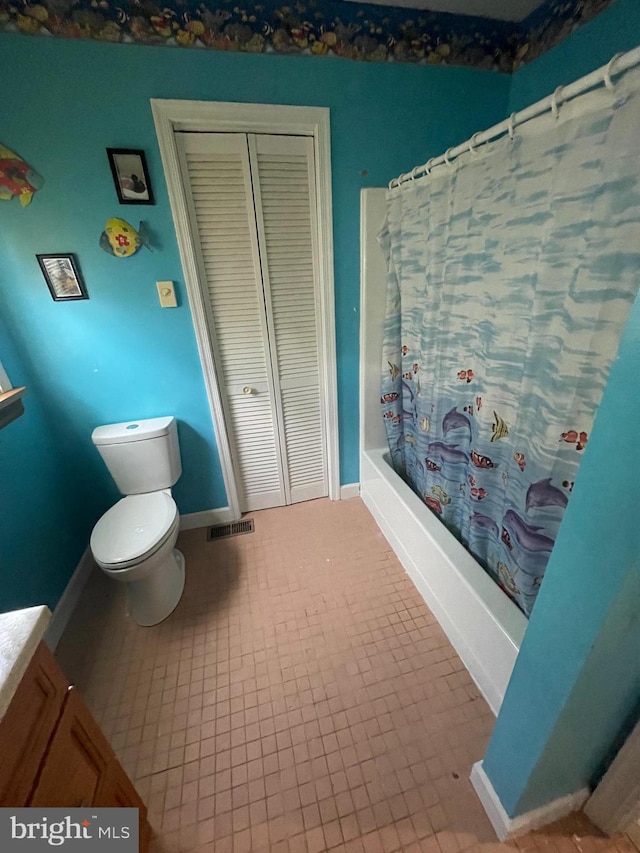 full bathroom with vanity, shower / tub combo with curtain, toilet, and tile patterned floors