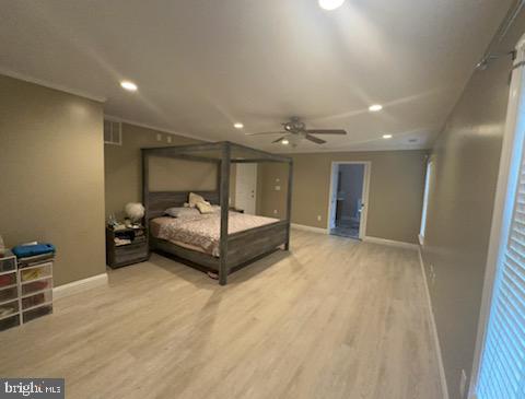 bedroom with light hardwood / wood-style flooring and ceiling fan