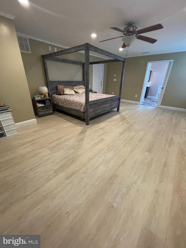 unfurnished bedroom featuring light hardwood / wood-style floors, ensuite bath, and ceiling fan