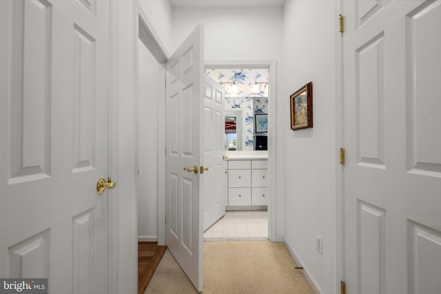 hallway with light colored carpet