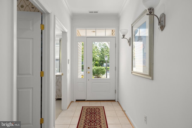 entryway with light tile patterned floors and ornamental molding