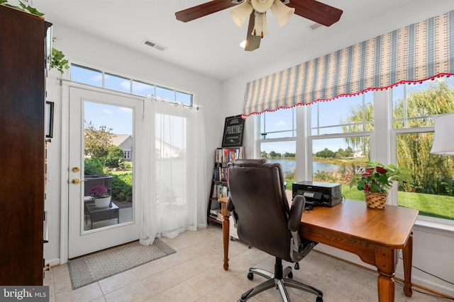 office featuring a water view, ceiling fan, and light tile patterned flooring