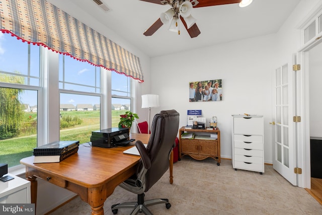 tiled home office featuring ceiling fan