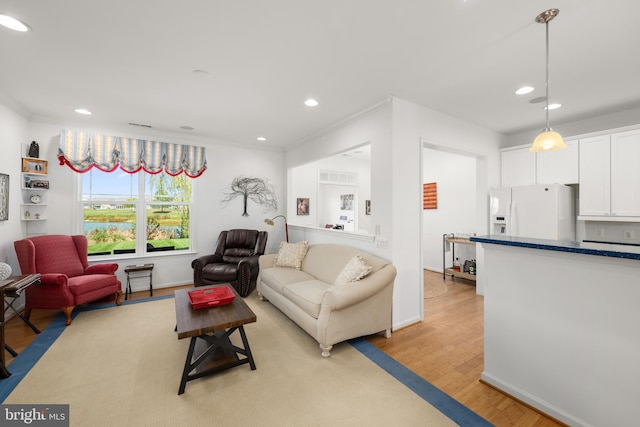 living room with light hardwood / wood-style flooring and ornamental molding