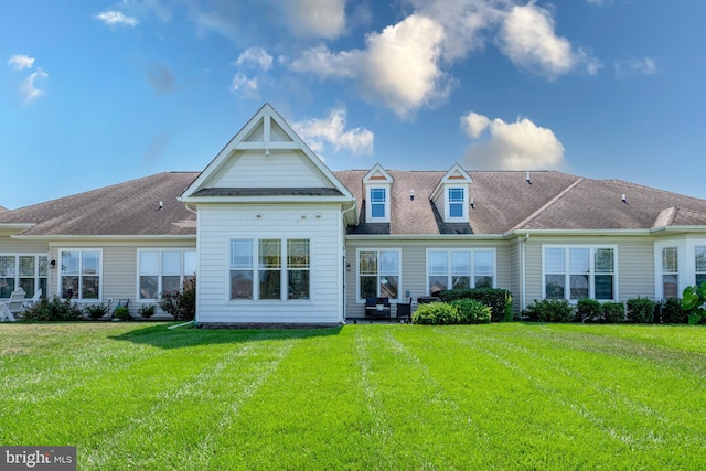 rear view of house with a yard