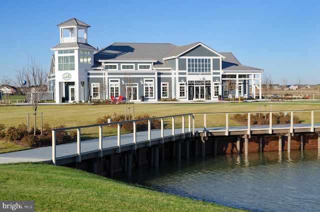 view of dock featuring a yard and a water view