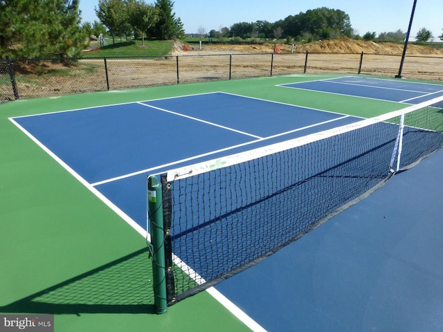 view of sport court with basketball hoop