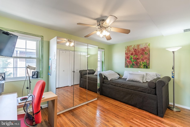 bedroom with ceiling fan and wood-type flooring