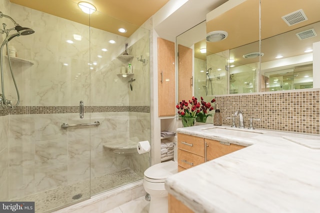 bathroom with toilet, a shower with door, tile walls, tasteful backsplash, and vanity