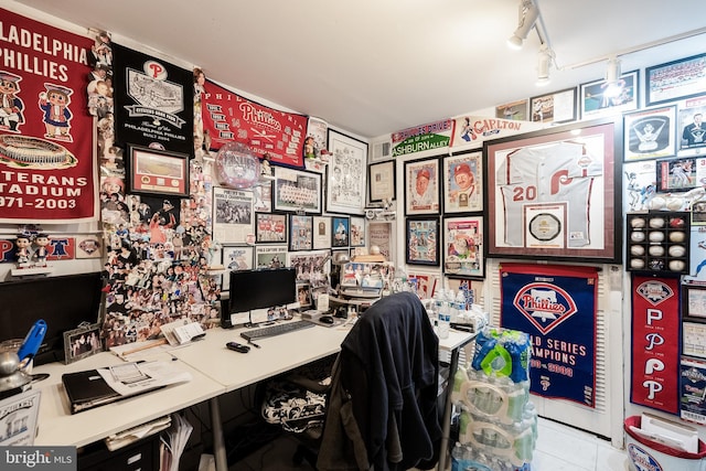 tiled home office featuring track lighting