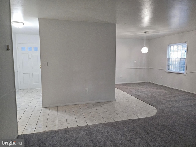 unfurnished room featuring light carpet