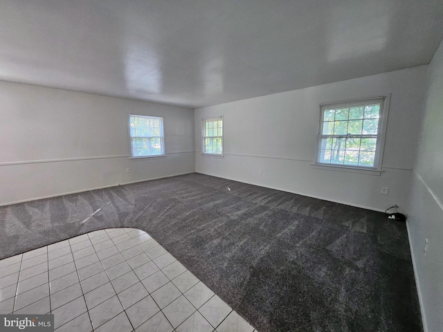 unfurnished room with light colored carpet