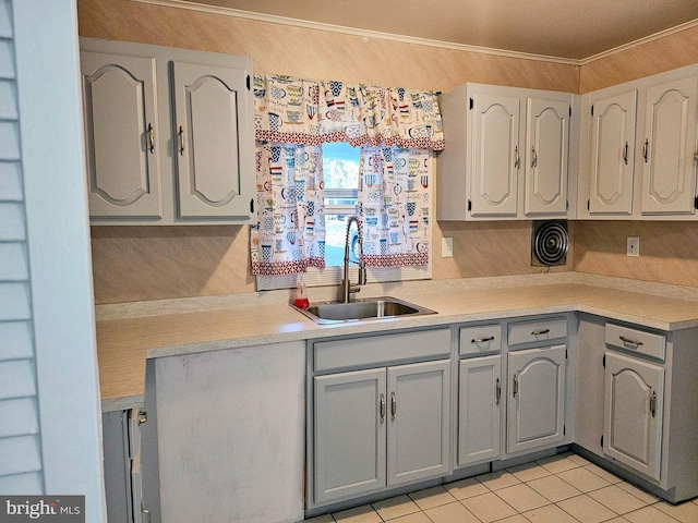 kitchen with light tile patterned floors, sink, and gray cabinetry