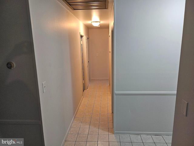 corridor with light tile patterned floors