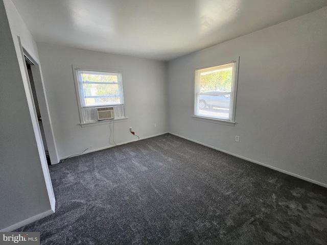 unfurnished bedroom with dark carpet