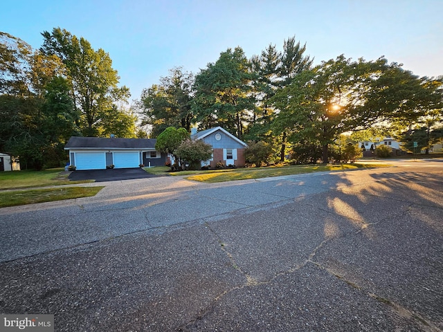 view of front facade featuring a garage and an outbuilding