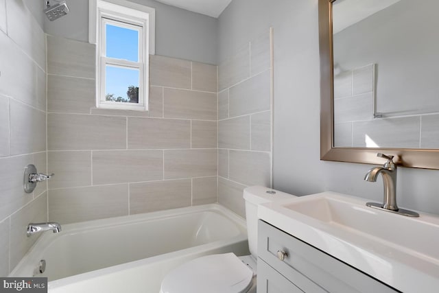 full bathroom with tiled shower / bath combo, vanity, and toilet