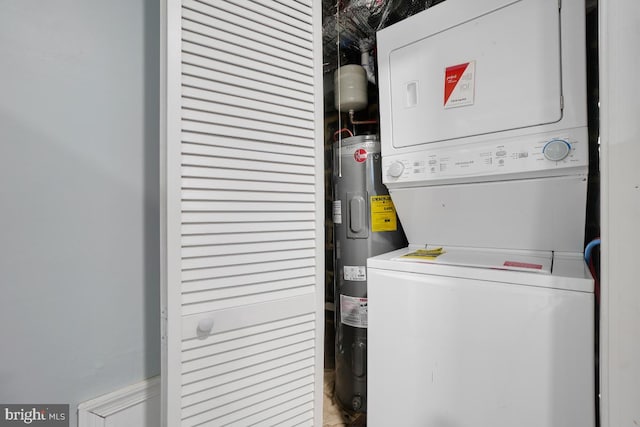 laundry room with stacked washer and dryer and water heater