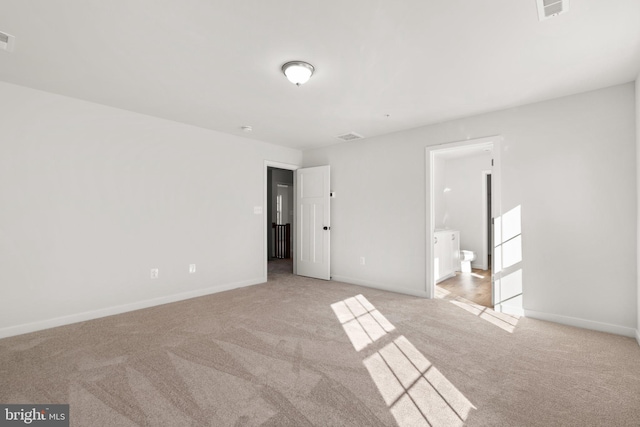 unfurnished room with light carpet