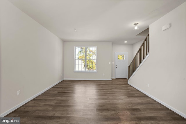 entryway with dark hardwood / wood-style flooring