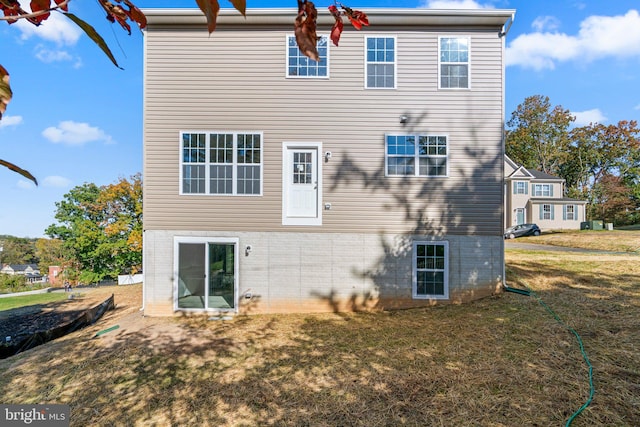 rear view of property featuring a yard