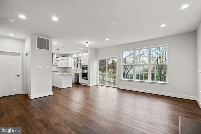 unfurnished living room featuring dark hardwood / wood-style flooring