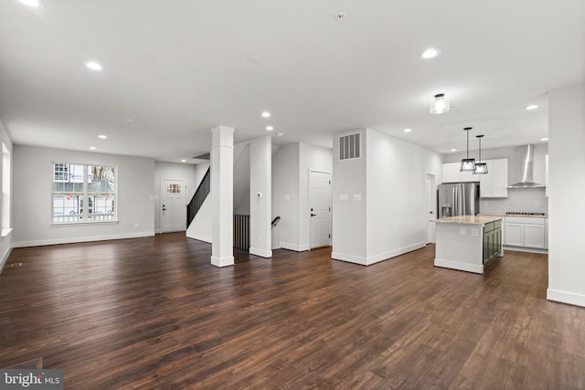 unfurnished living room featuring dark wood-type flooring