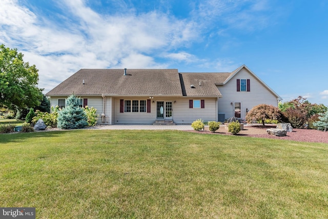 rear view of property with a lawn and a patio area