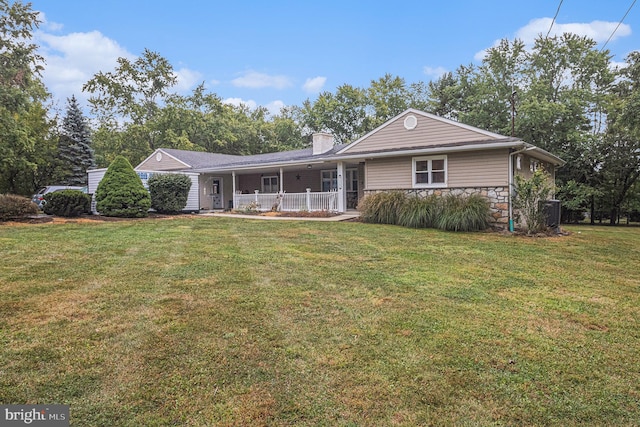 rear view of property with a lawn