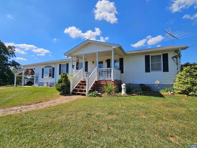 view of front of property with covered porch, a carport, and a front lawn