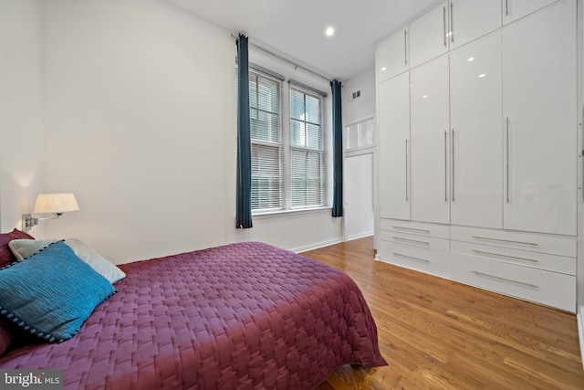 bedroom with hardwood / wood-style floors