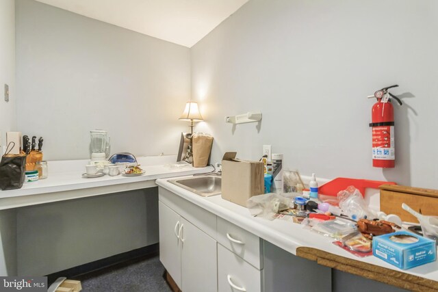 interior space with vaulted ceiling and sink