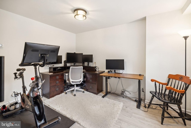 office with light hardwood / wood-style flooring