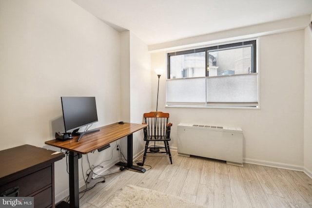 home office featuring light wood-type flooring and radiator heating unit