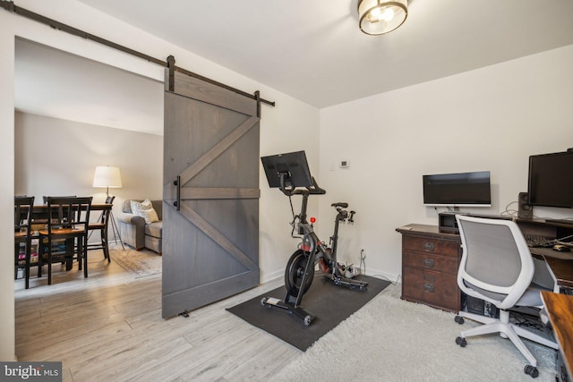 office area featuring light hardwood / wood-style floors and a barn door