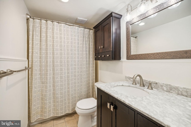 bathroom featuring tile patterned flooring, vanity, and toilet